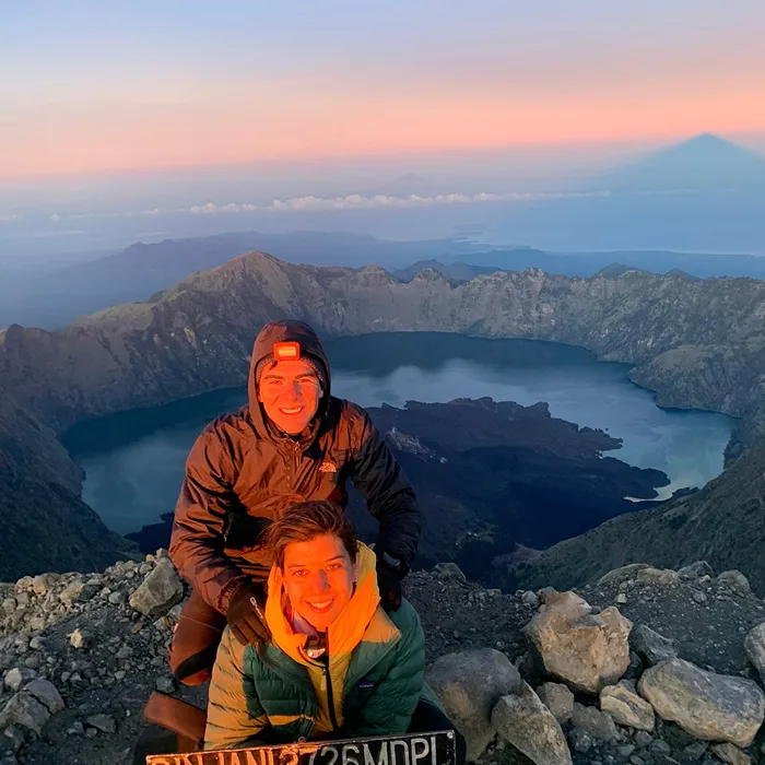 Trekkers approaching the mount rinjani summit at sunrise