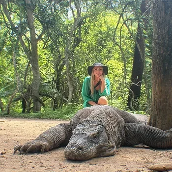 A Girl Behind Komodo Dragon During Komodo Island Tours A Girl Behind Komodo Dragon During Komodo Island Tours